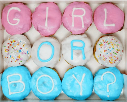 Gender reveal donuts with pink and blue frosting